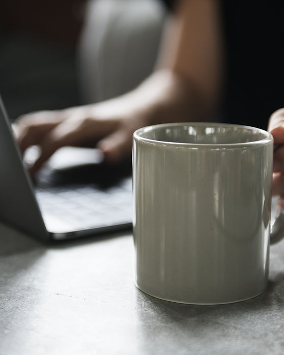 Beverage Mug and a Laptop