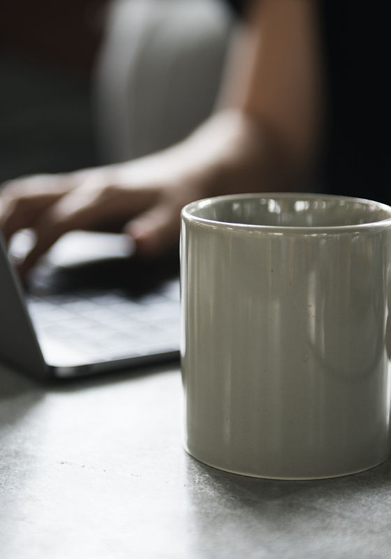 Beverage Mug and a Laptop