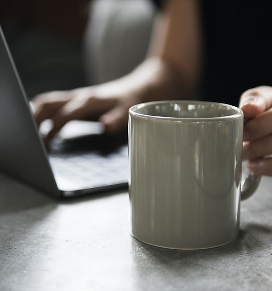 Beverage Mug and a Laptop