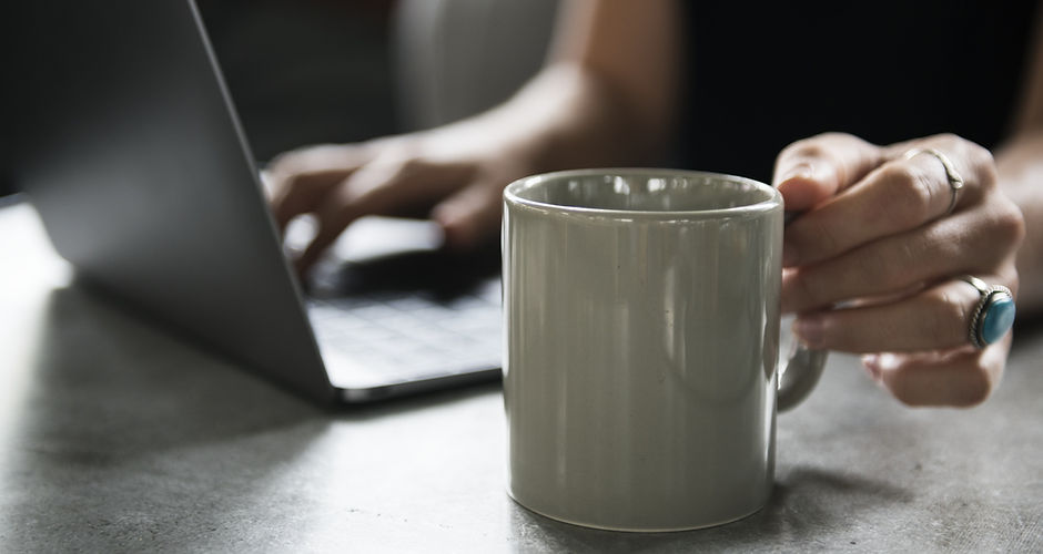 Beverage Mug and a Laptop