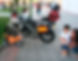 A little boy who parked his tricycle next to my motorbike.