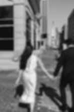 Couple holding hands and walking through the Indiana State House during formal engagement photos in Indianapolis