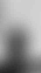 Groom adjusting his tie while getting ready at The Conrad Indianapolis, captured by a wedding photographer near me.