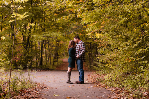 Jen & Will's engagement photos at Eagle Creek Park amid vibrant fall foliage.