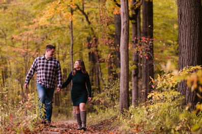 Jen & Will's engagement photos at Eagle Creek Park amid vibrant fall foliage.
