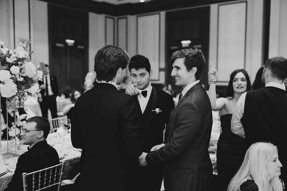 Guests sharing laughter and joy during the wedding reception at The Conrad Indianapolis, photographed by Rogue Image Photo.