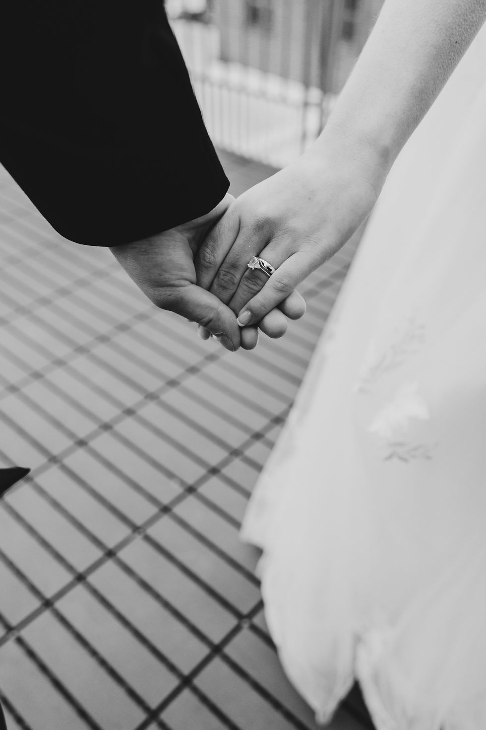 A couple holds hands during their wedding day