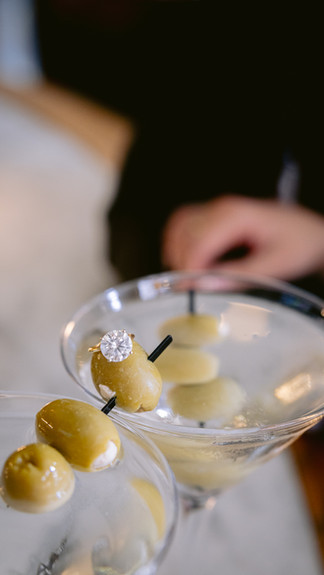 Couple enjoying cocktails during engagement photos at Prime 47 in downtown Indianapolis