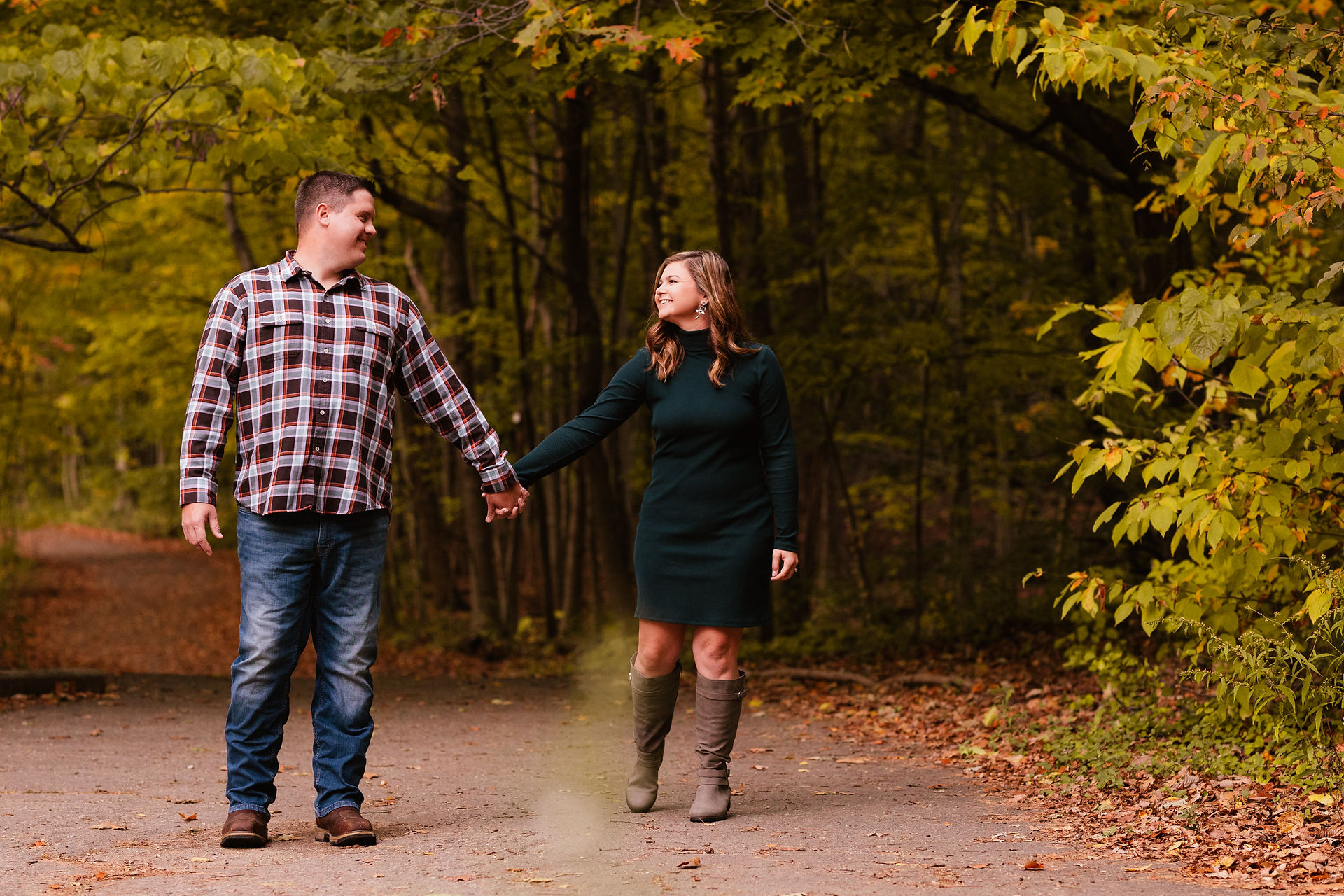 Jen & Will's engagement photos at Eagle Creek Park amid vibrant fall foliage.