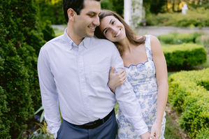 Newfields engagement photos in Indianapolis featuring a couple walking through garden pathways during a romantic documentary style engagement session.