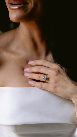 Elegant bridal portrait in wedding gown surrounded by classic cars inside Fort Wayne barn