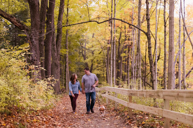 Jen & Will's engagement photos at Eagle Creek Park amid vibrant fall foliage.