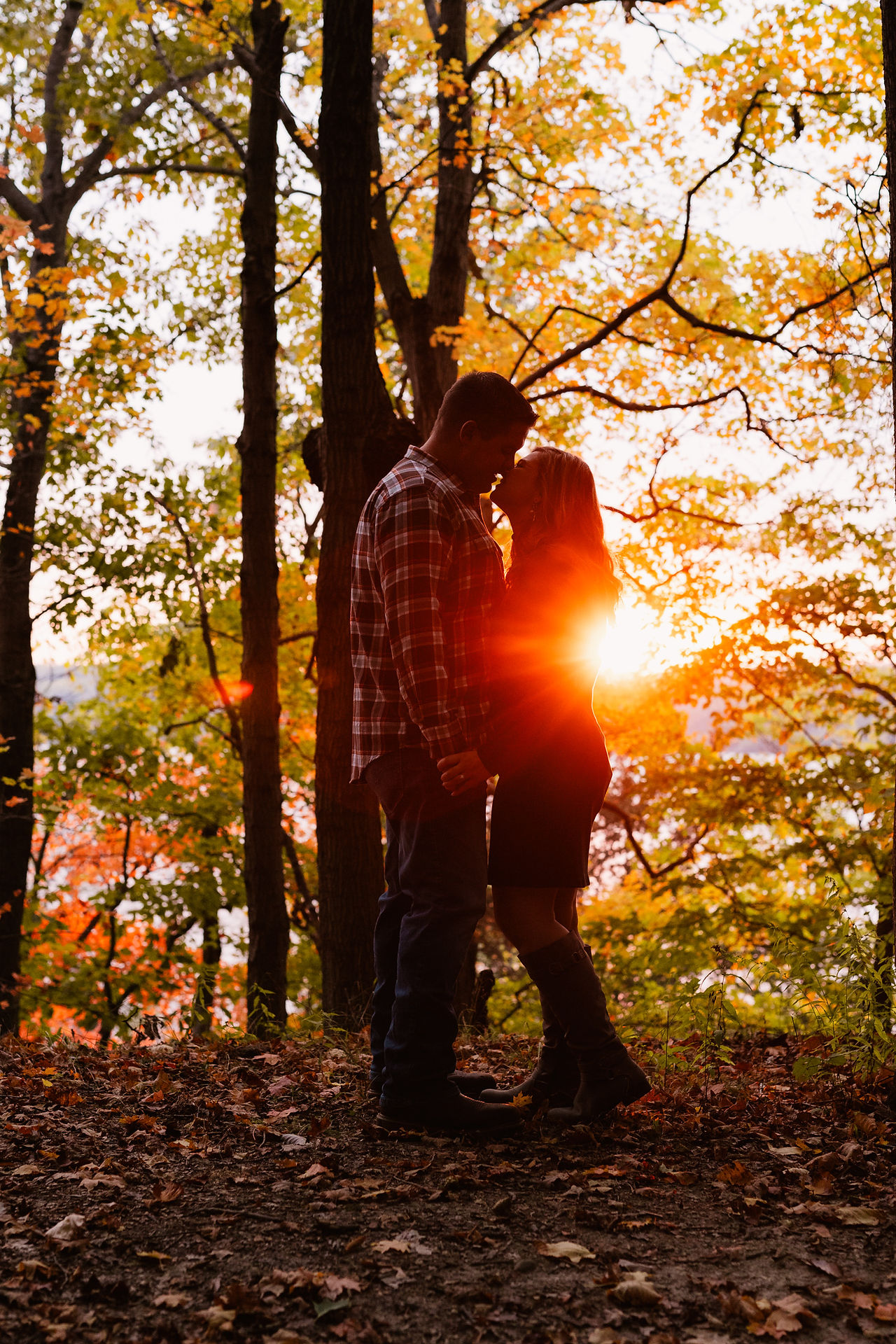 Jen & Will's engagement photos at Eagle Creek Park amid vibrant fall foliage.