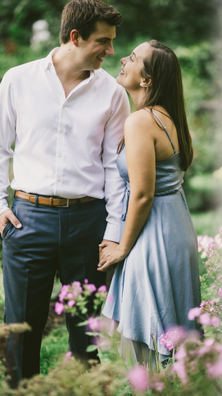 Newfields engagement session - Allie & Chris framed by vibrant summer flowers.