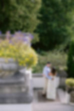 Couple walking hand-in-hand across Newfields lawn.