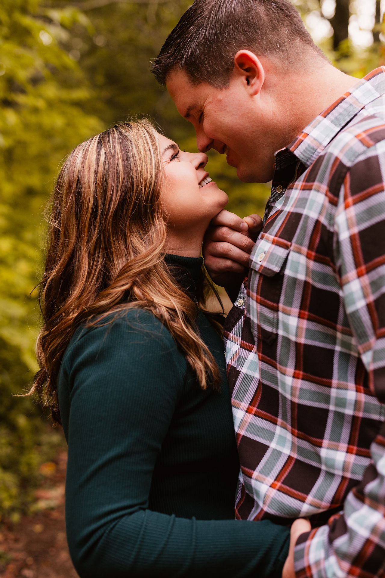 Jen & Will's engagement photos at Eagle Creek Park amid vibrant fall foliage.