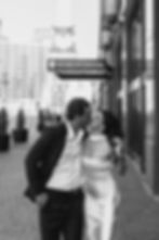 Timeless engagement portrait of couple walking through downtown Indianapolis in formal attire