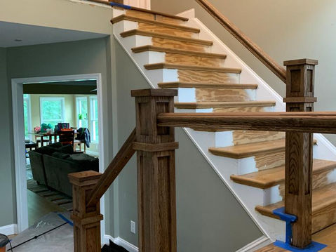 Wooden staircase with handrails and risers. Natural wood and white paint. Seta Hardwood