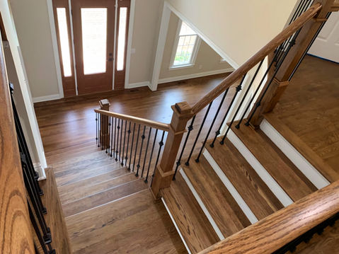 Wooden staircase view with railing leading to wood floor Seta Hardwood