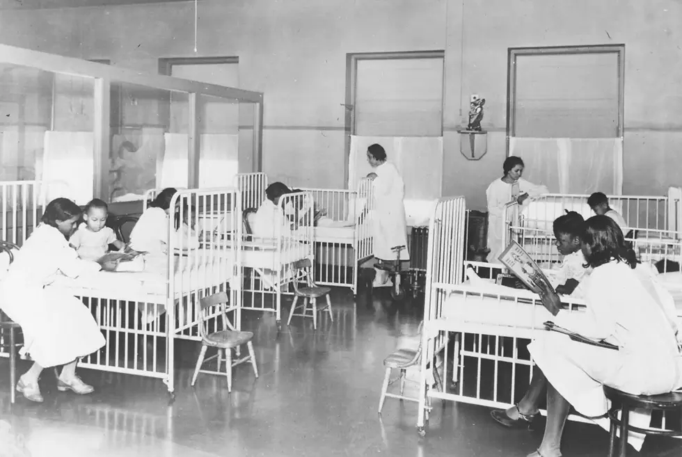 Nurses attend to patients in this historical photo of the children's ward inside Wheatley-Provident Hospital, a Black hospital in Kansas City, Missouri.