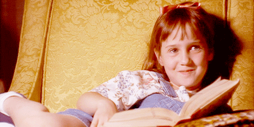 Matilda laughing and reading a book