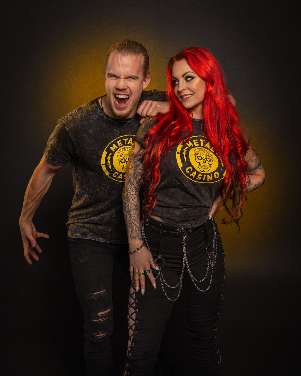 Sara Hedgren and Ragnar Östberg in Metal Casino t-shirts in a photo studio.