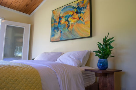 This vibrant guest room utilizes custom wooden walnut side tables.