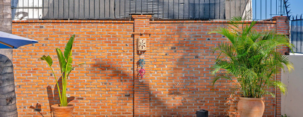 Brick wall, plants and speaker hookup at Casa Pulpo