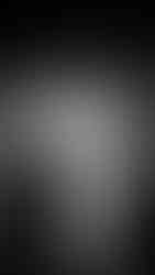 an alternative wedding couple pose intimately under a gothic stone archway