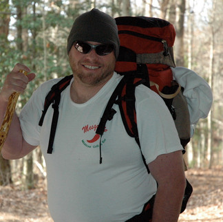 Chris with backpack and walking stick