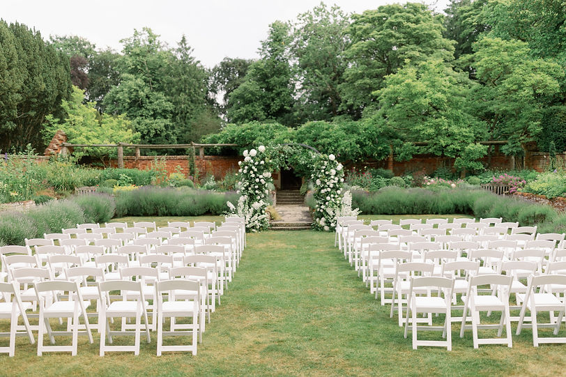luxury-outdoor-garden-wedding-ceremony-with-large-bespoke-floral-arch-at-a-private-estate.