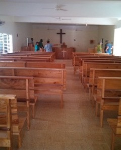 Members of Iglesia Santo Tomas are helping move the twenty-five new pews into the sanctuary of Iglesia Santo Tomas.