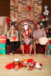 Festival visitors taking a portrait photo with Nesian Santa at the holiday photo booth