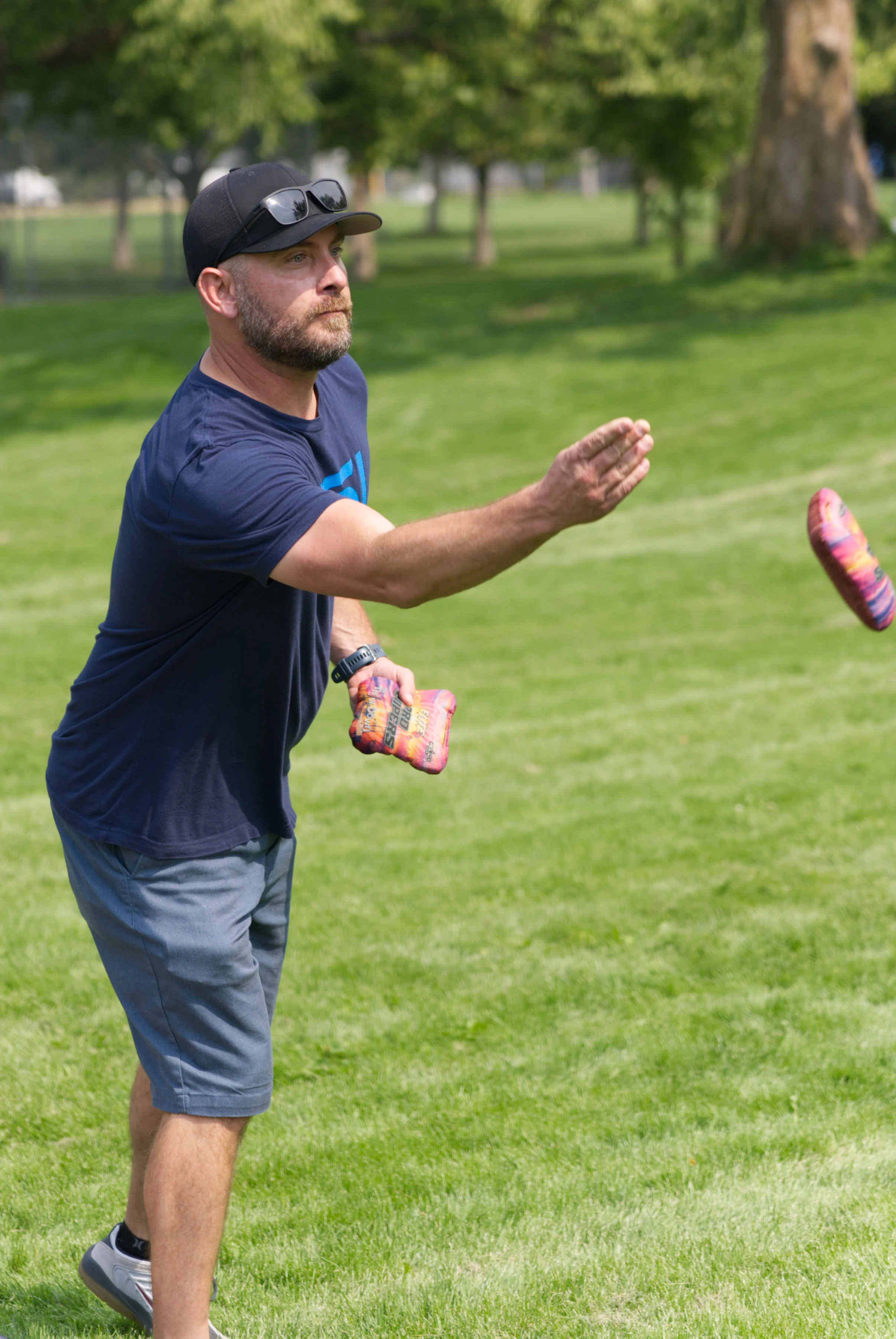 Nick Wallace throwing a bean bag in the final game of cornhole.