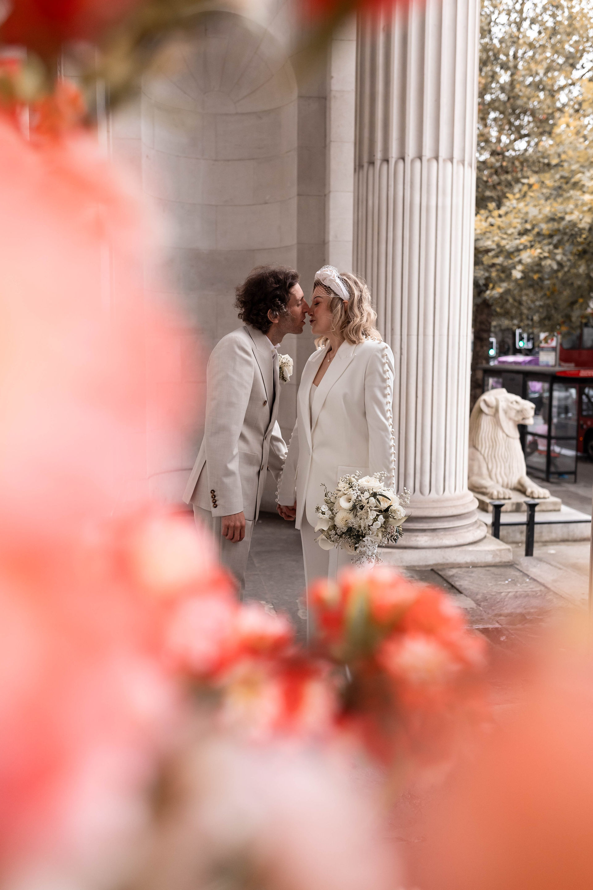 A kiss amongst the beautiful flowers outside the Old Marylebone Town Hall