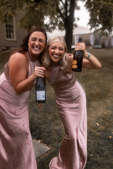 The bridesmaids are all smiles post prosecco spray