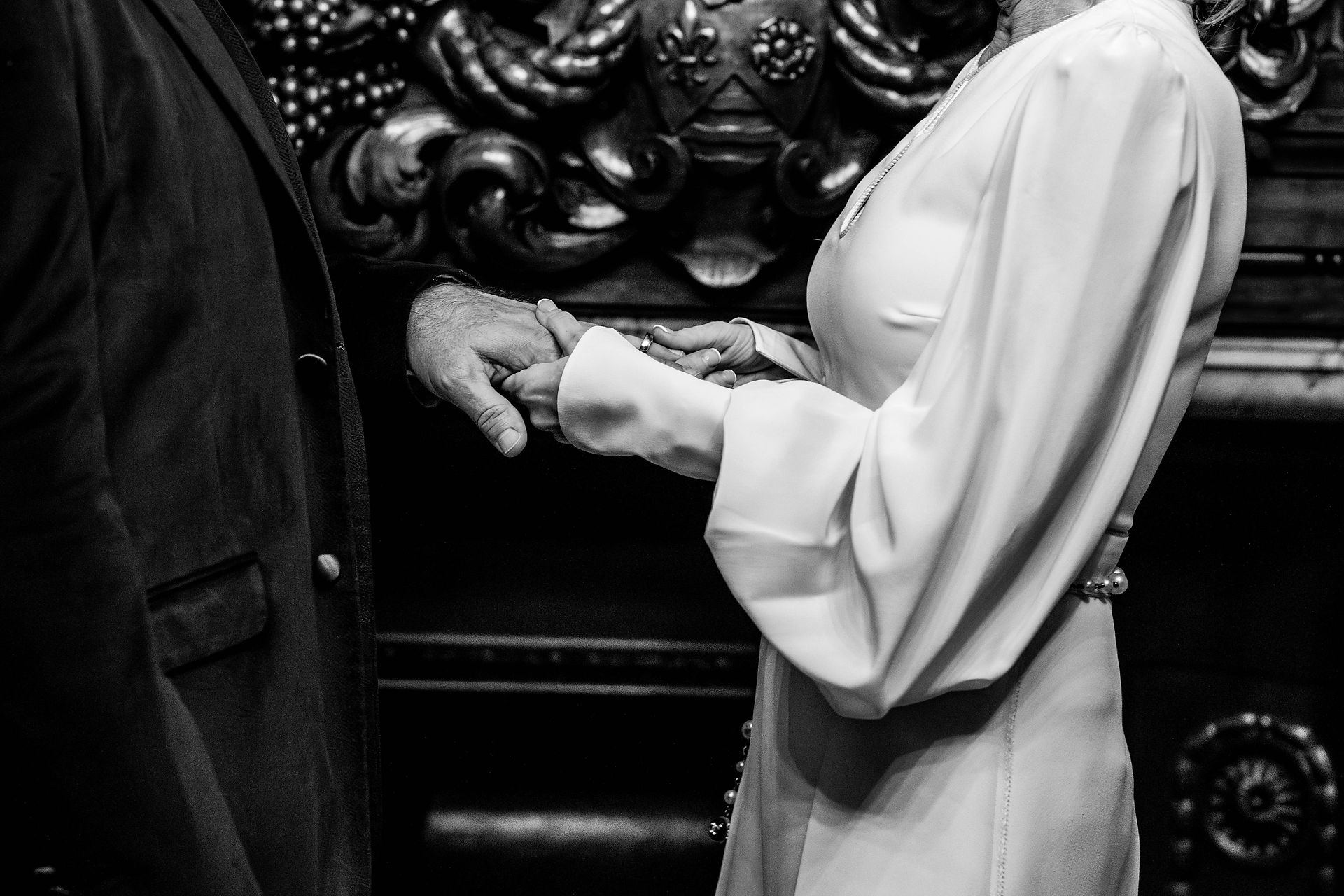 The happy couple hold hands through the ceremony