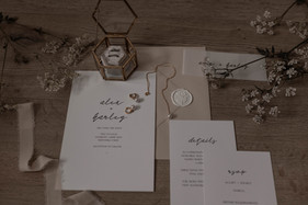 Stationery flat lay; showcases the stunning and simple wedding stationery alongside the bridal accessories