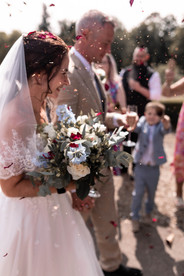 The bride and groom doing a confetti line up at Brocket Hall