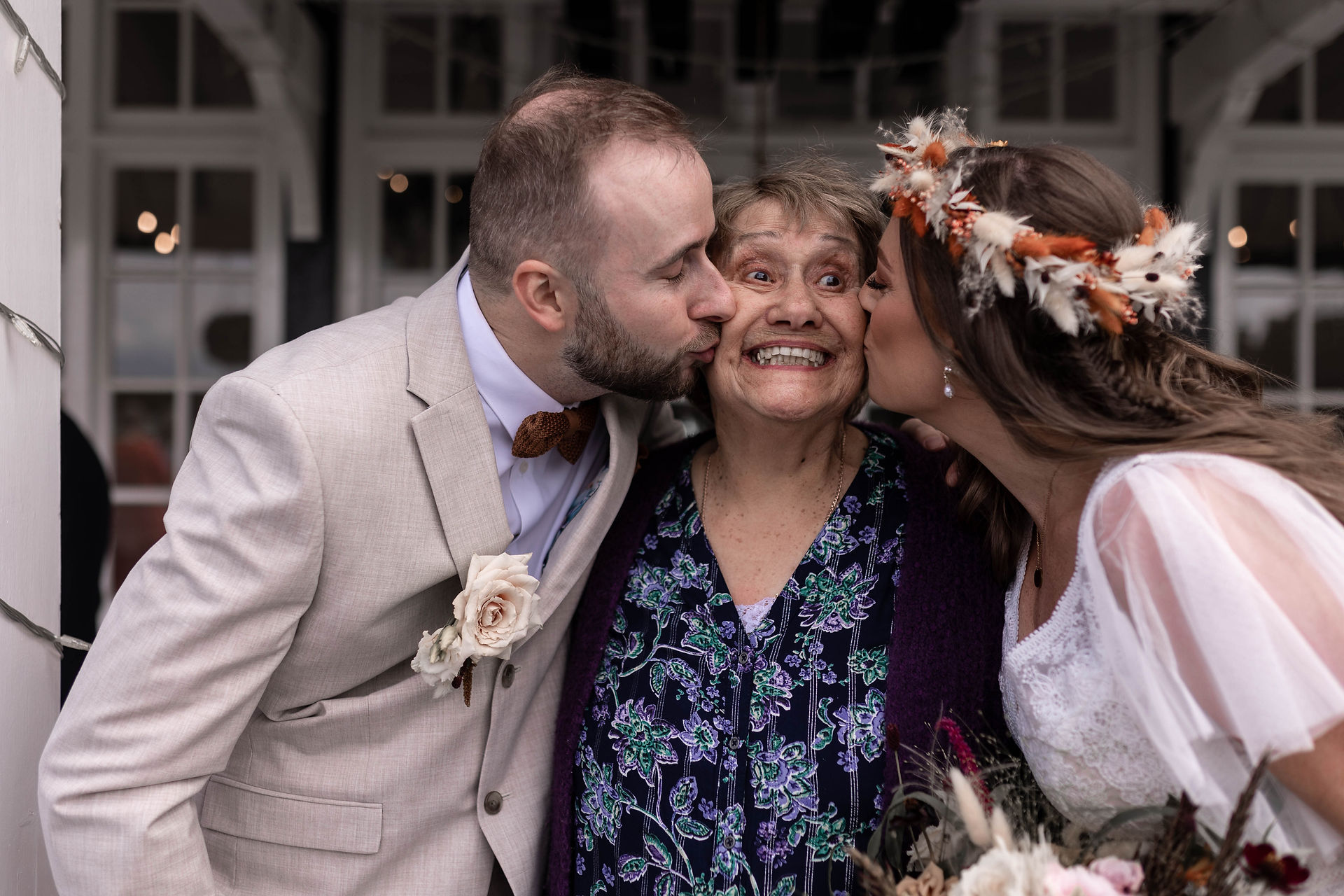 kisses with family with the bride and groom