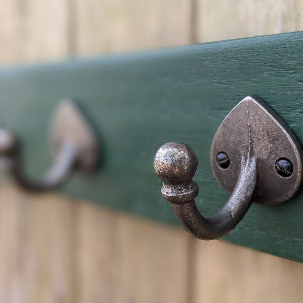 wooden rack painted in Amsterdam green fitted with four decorative hooks