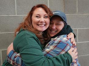 Two women hugging and smiling.