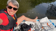 Alex Pocock the river testing coordinator on her paddle board