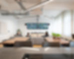 MAG - comfortable break out area with sofas and TV screens