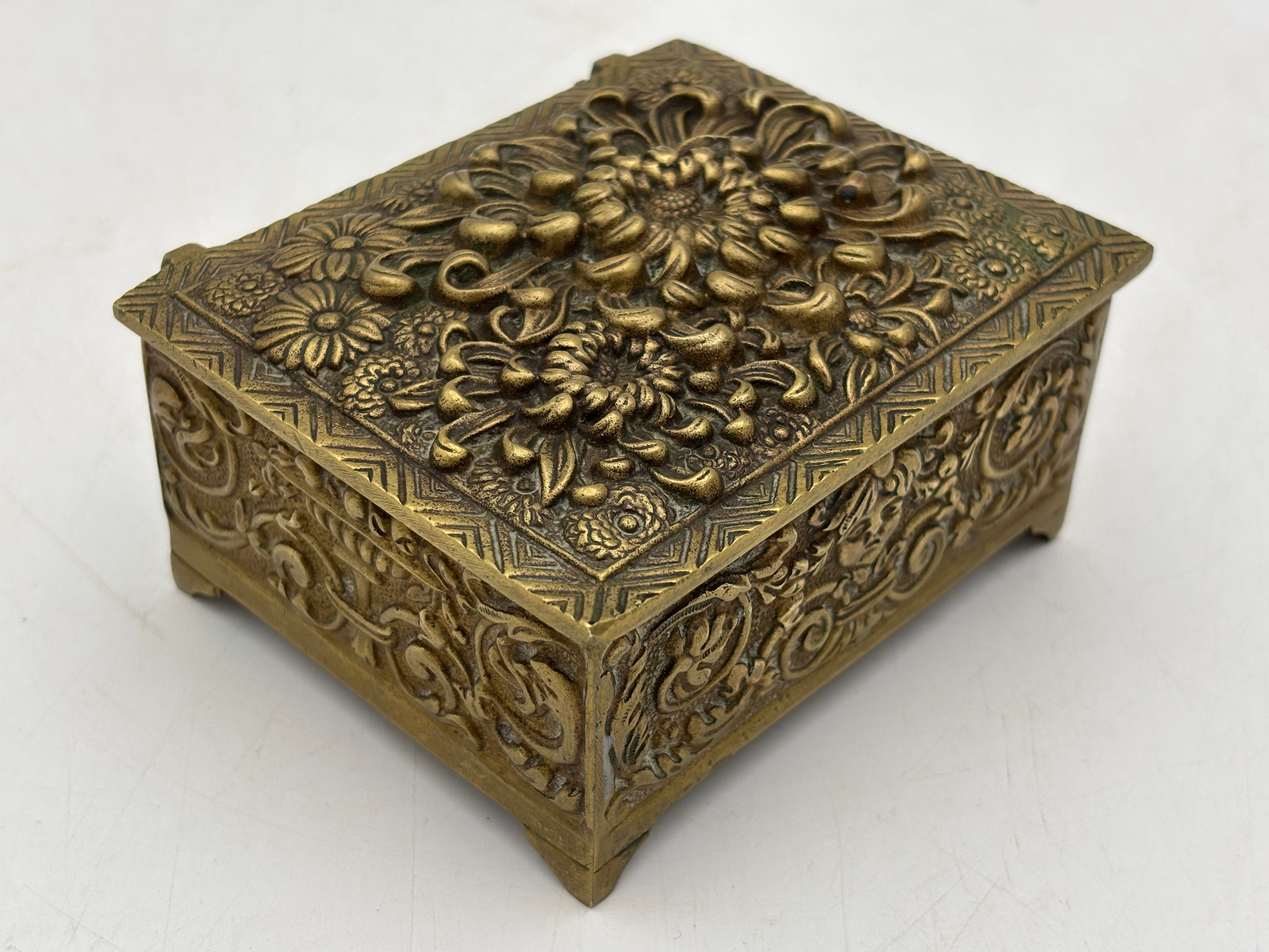 Vintage heavy cast brass trinket or jewelry box decorated in a Rococo style.