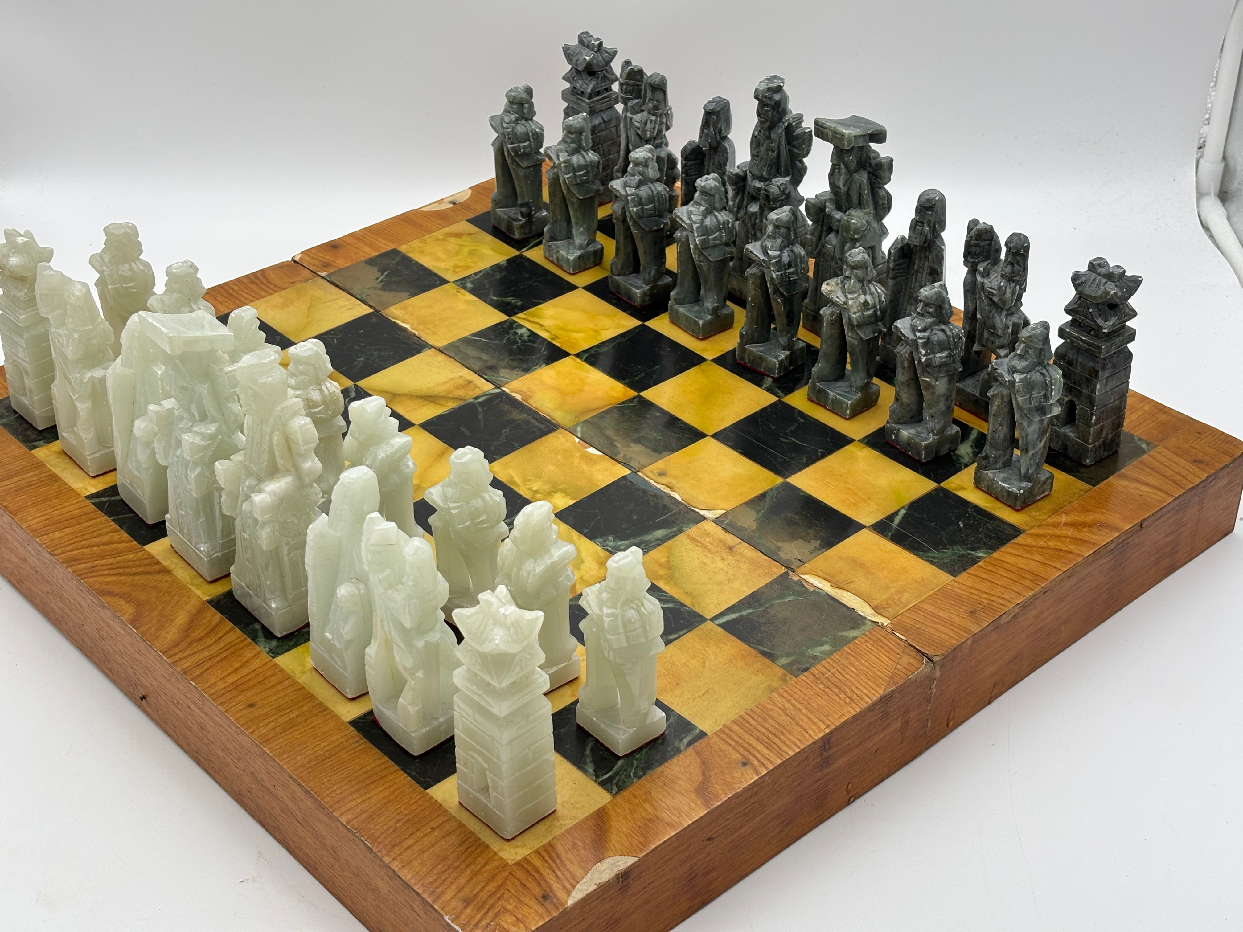 Vintage oriental hand-carved stone chess set featuring oriental-style figural pi