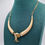 Thumbnail: Antique Gold Elephant & Tusk Style Necklace