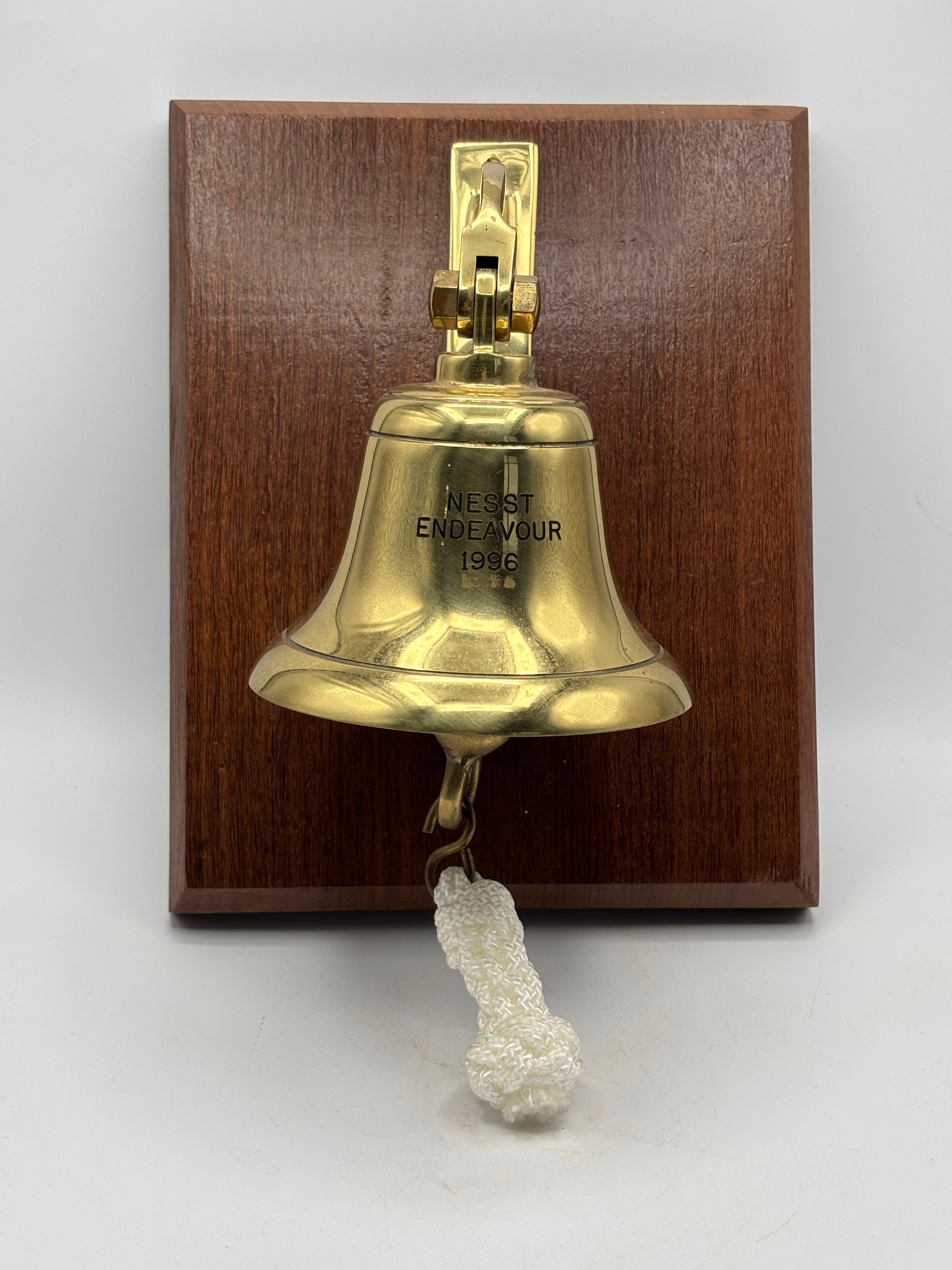 Solid Brass Bell mounted on wooden plaque.