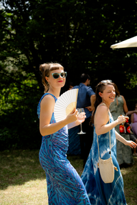 Invitadas sonriendo a cámara durante la fiesta con vestidos de verano