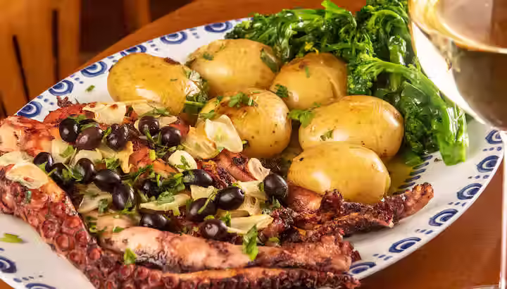 Polvo à Lagareiro, Portuguese roasted octopus with garlic, olive oil, and smashed potatoes.